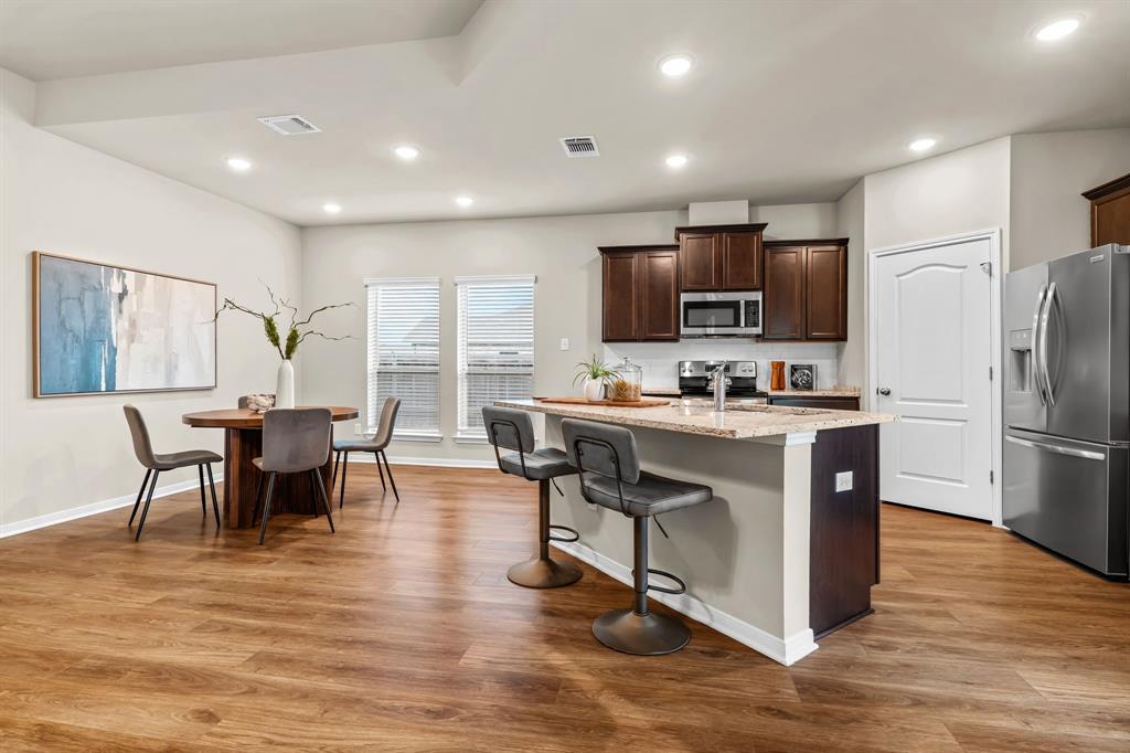 11233 Solar Street Lorena, TX 76655 - Photo 10 of 33 open layout kitchen and dining area; kitchen island with seating
