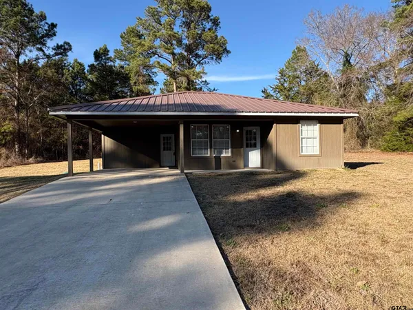 a house with trees in the background