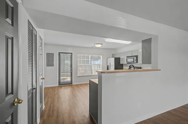 a kitchen with stainless steel appliances a refrigerator a stove top oven a sink and dishwasher