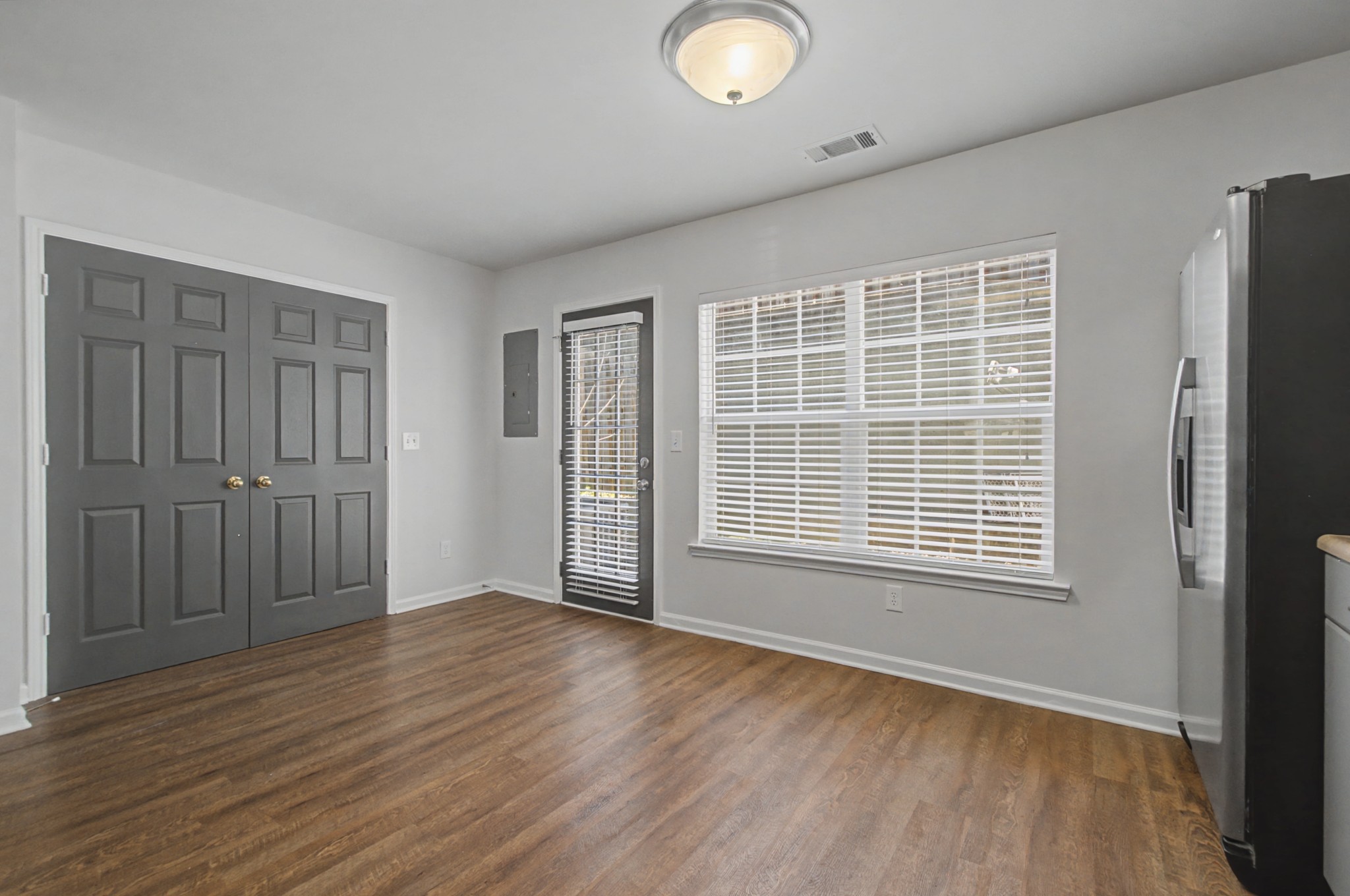 7405 Rice Court Fairview, TN 37062 - Photo 18 of 33 an empty room with wooden floor and windows