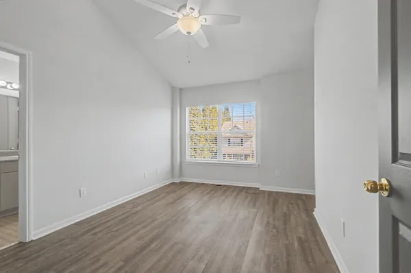 a view of wooden floor and windows in a room