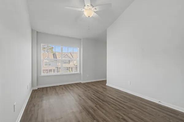 a view of an empty room with wooden floor