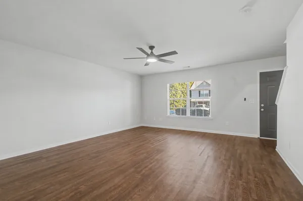 wooden floor in an empty room with a window