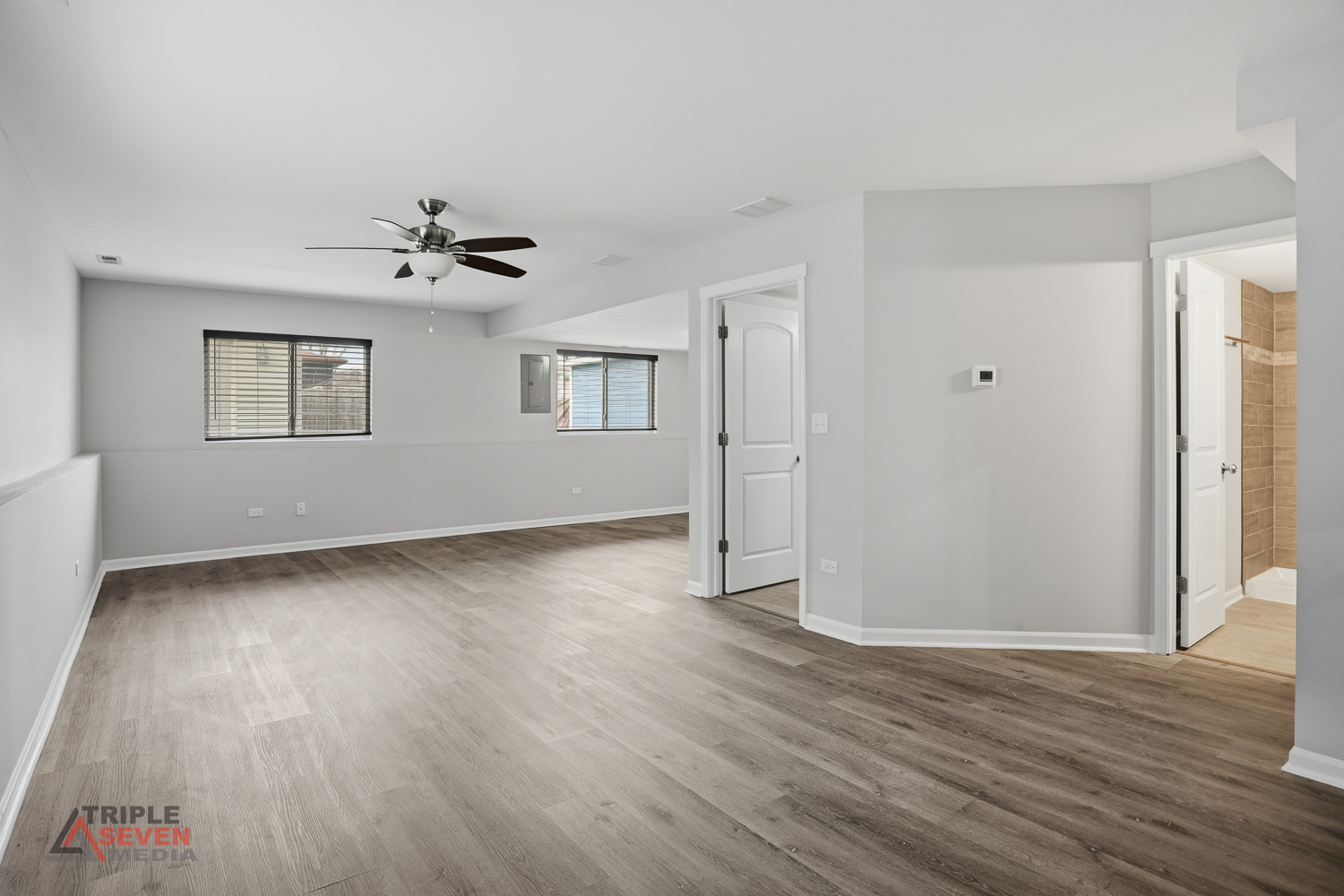 14528 Kolin Avenue Midlothian, IL 60445 - Photo 22 of 29 an empty room with wooden floor and windows