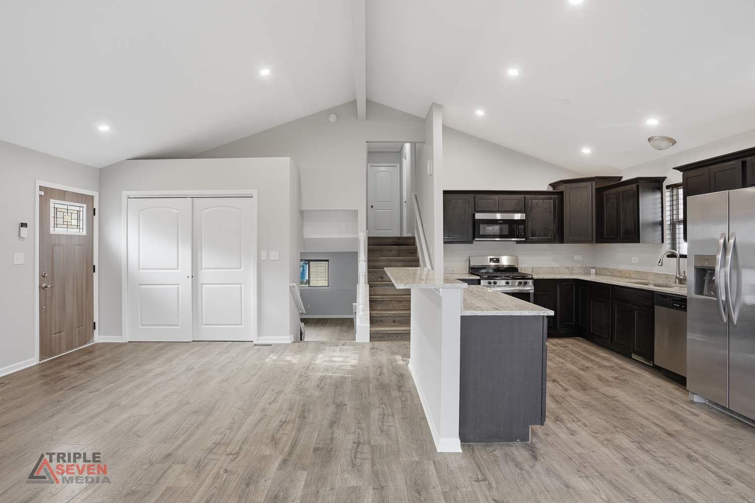 14528 Kolin Avenue Midlothian, IL 60445 - Photo 4 of 29 a large kitchen with a center island wooden floor stainless steel appliances and cabinets