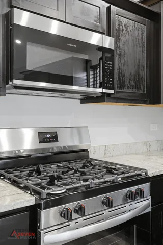 a stove sitting inside of a kitchen with granite countertop
