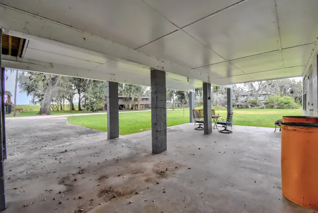 a view of a house with a yard and pathway