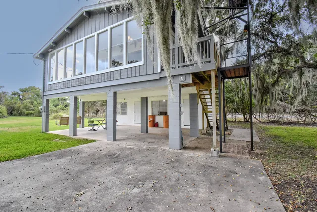 a view of trees and cars from a balcony