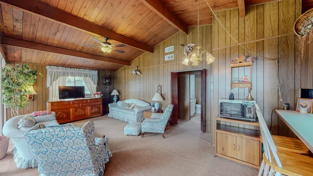 a living room with lots of furniture and a chandelier