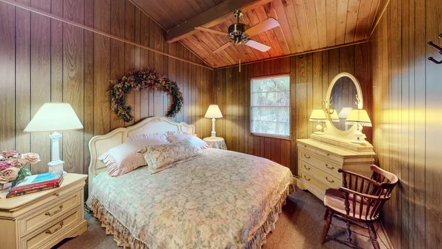 a bedroom with a bed and a painting on the wall