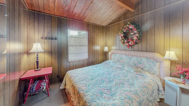 a view of house with a big yard and large trees