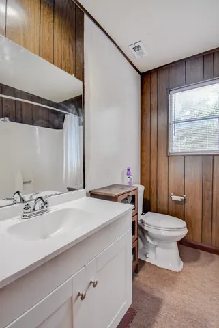 a view of a house with a yard and a tree