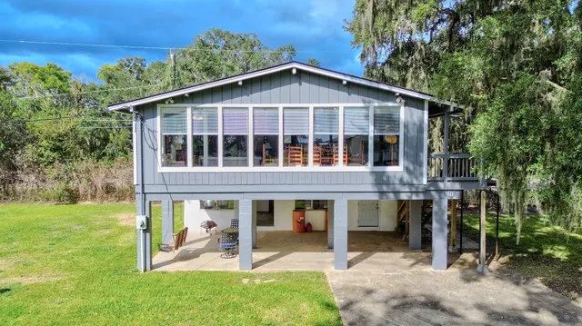 a view of a house with yard and sitting area