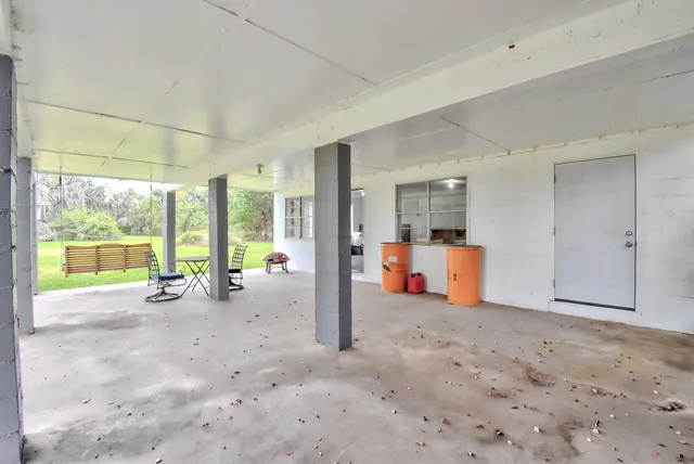 a very nice looking room with a large window and furniture