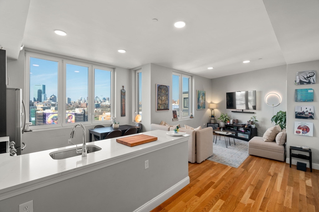 10 Taber Street, Unit 608 Boston, MA 02119 - Photo 12 of 20 a large white kitchen with a large window and stainless steel appliances