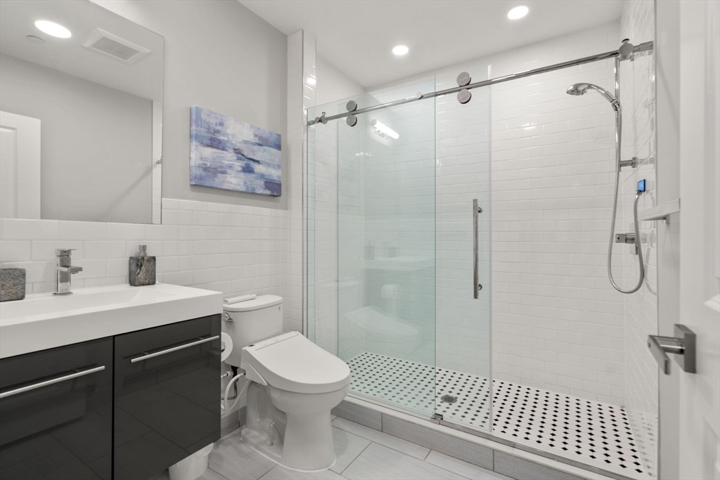 10 Taber Street, Unit 608 Boston, MA 02119 - Photo 15 of 20 a bathroom with a sink a toilet and shower