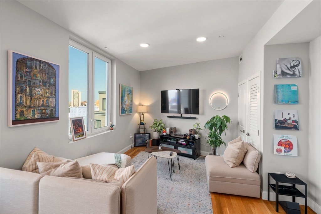 10 Taber Street, Unit 608 Boston, MA 02119 - Photo 16 of 20 a living room with furniture and a flat screen tv