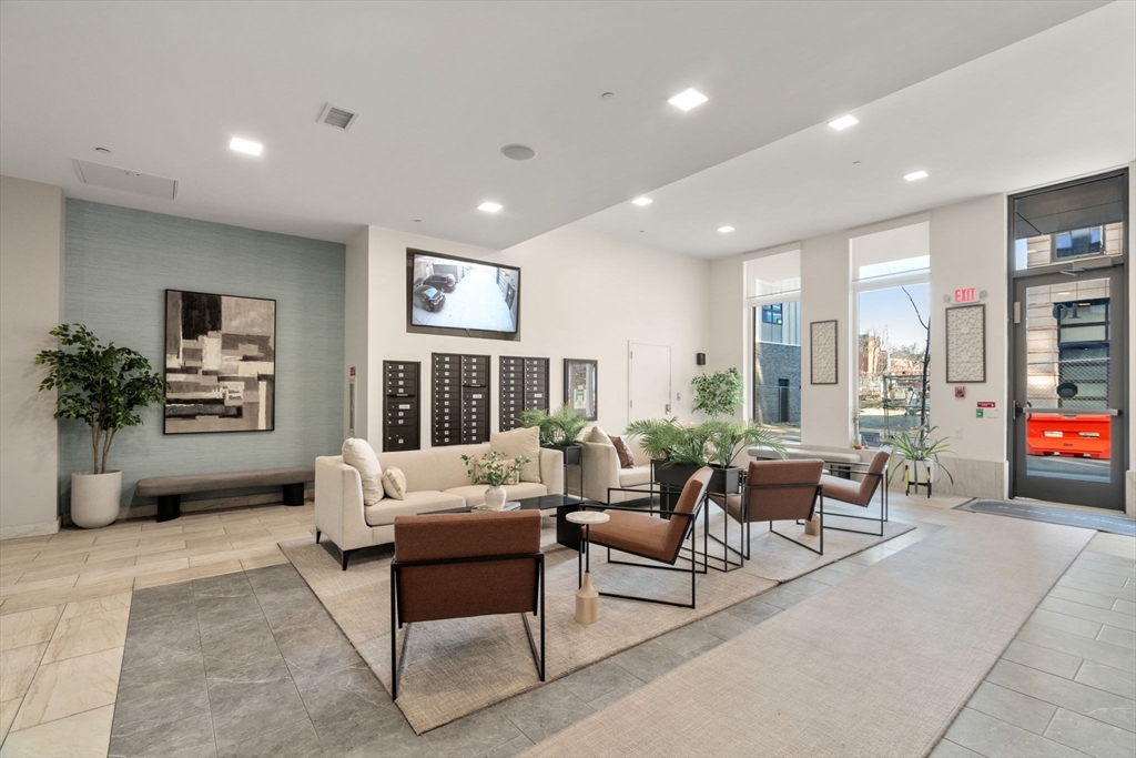 10 Taber Street, Unit 608 Boston, MA 02119 - Photo 2 of 20 a living room with furniture and a fireplace