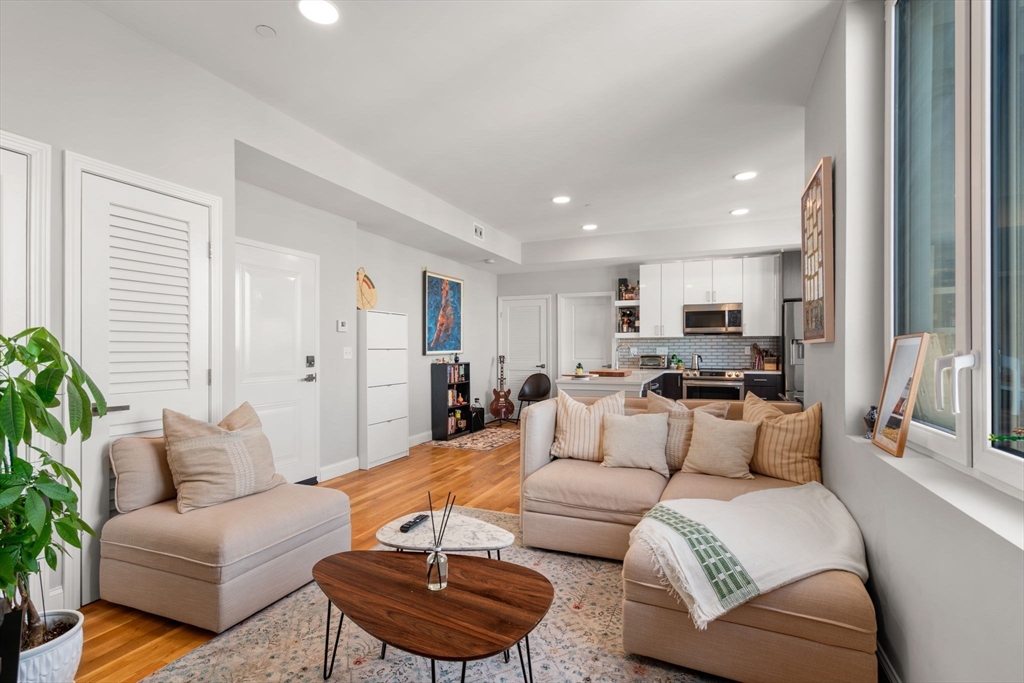 10 Taber Street, Unit 608 Boston, MA 02119 - Photo 6 of 20 a living room with furniture and a large window