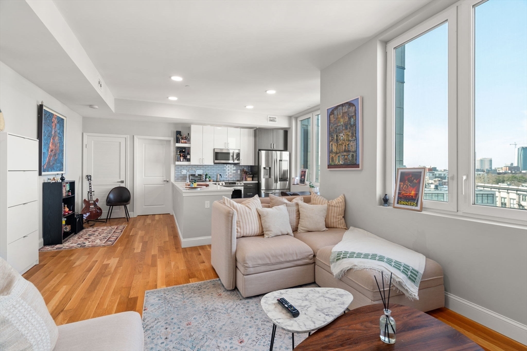 10 Taber Street, Unit 608 Boston, MA 02119 - Photo 8 of 20 a living room with furniture and a large window