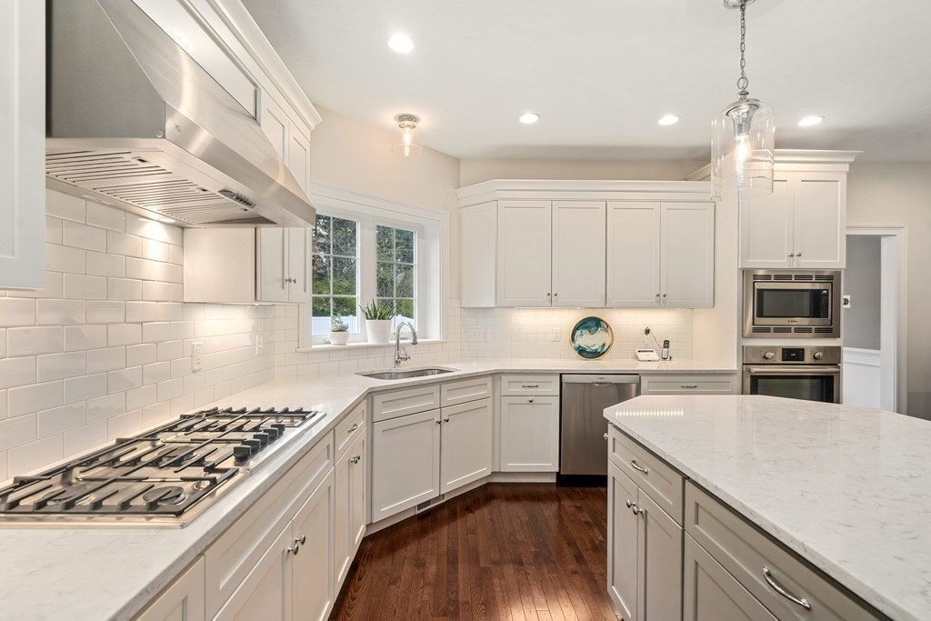 3 Dutton Drive Mansfield, MA 02048 - Photo 14 of 42 a kitchen with a sink stainless steel appliances and cabinets