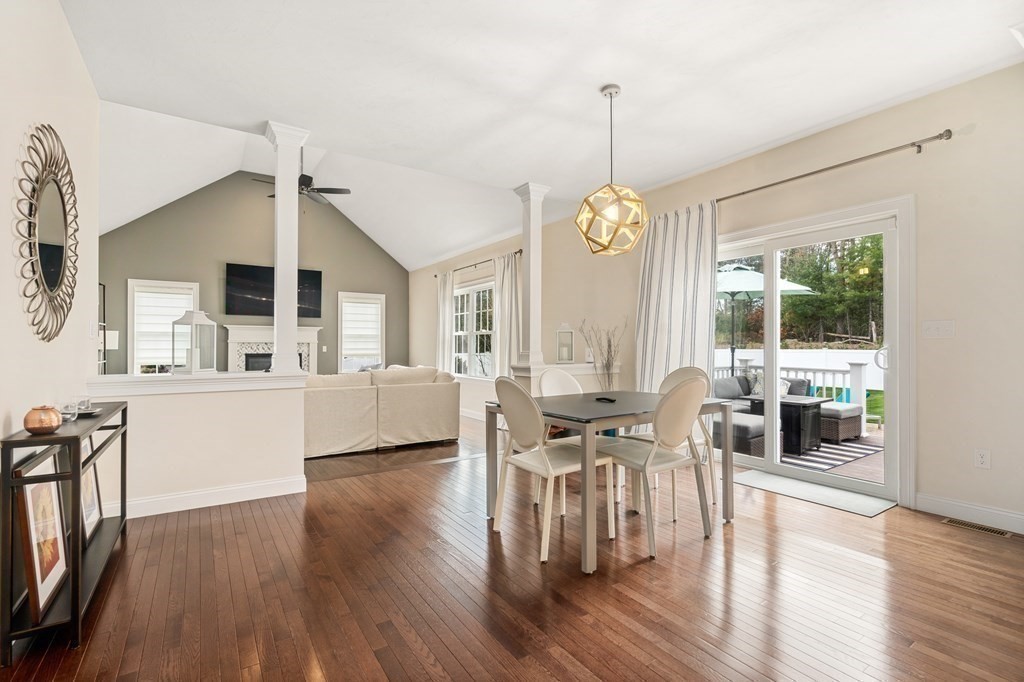 3 Dutton Drive Mansfield, MA 02048 - Photo 17 of 42 a view of a dining room and livingroom with furniture wooden floor a rug a chandelier