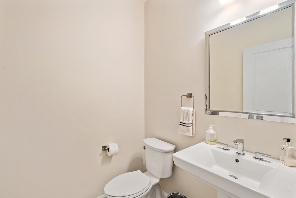 3 Dutton Drive Mansfield, MA 02048 - Photo 23 of 42 a white toilet sitting next to a bathroom sink