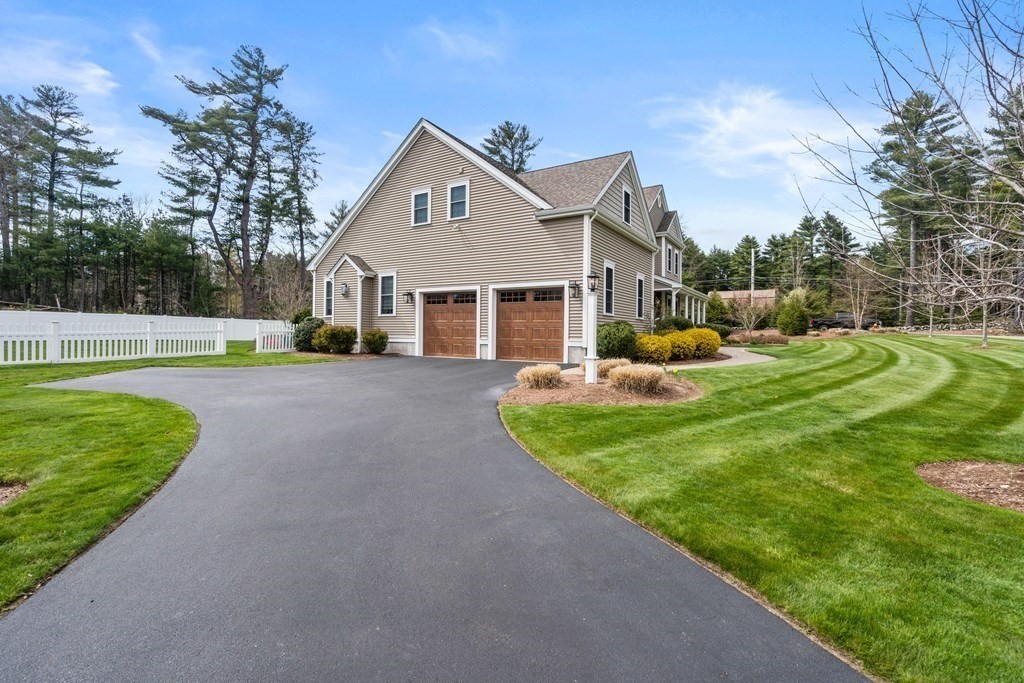 3 Dutton Drive Mansfield, MA 02048 - Photo 3 of 42 a front view of a house with a yard table and chairs