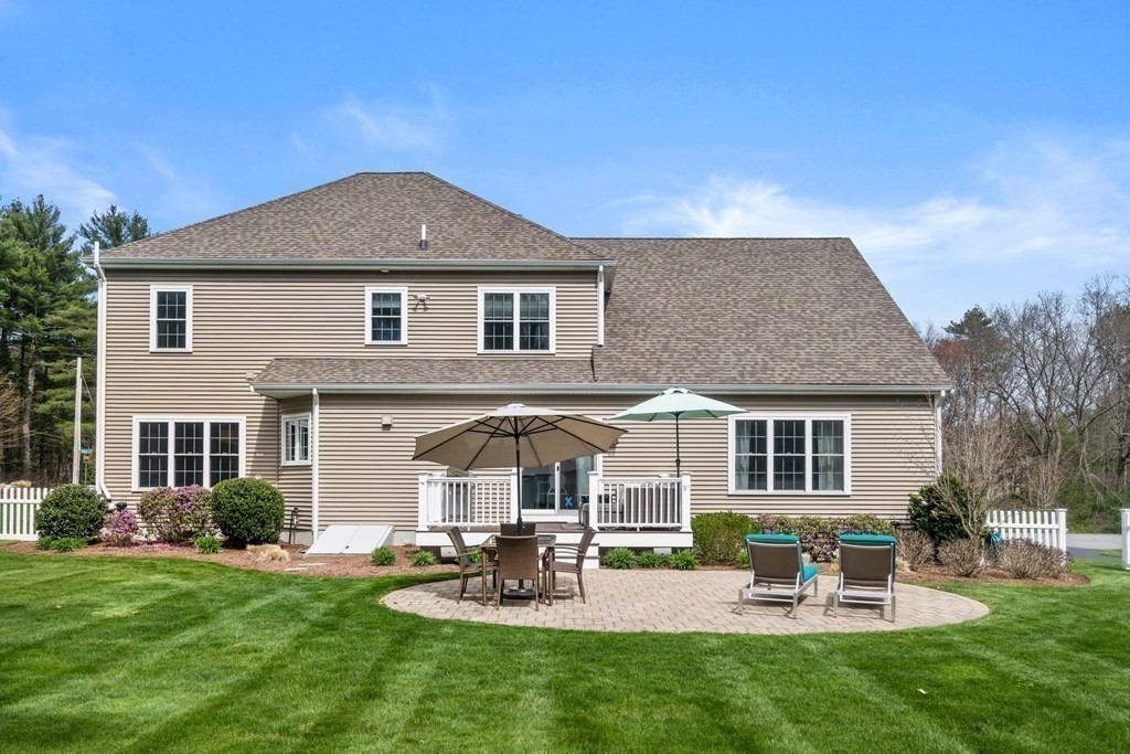 3 Dutton Drive Mansfield, MA 02048 - Photo 7 of 42 a front view of a house with a garden and patio