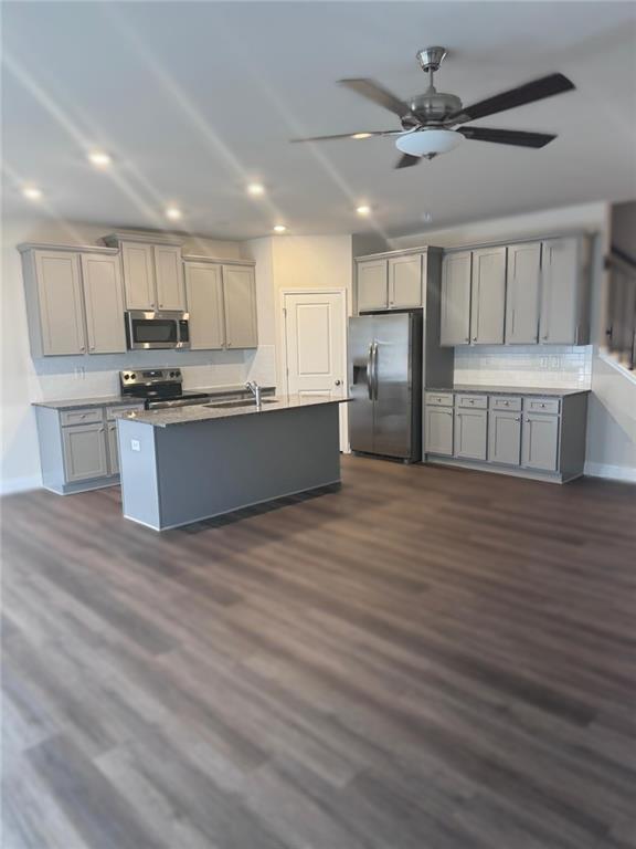 855 Pensive Run Dacula, GA 30019 - Photo 2 of 8 a kitchen with stainless steel appliances kitchen island granite countertop a stove a sink and a refrigerator