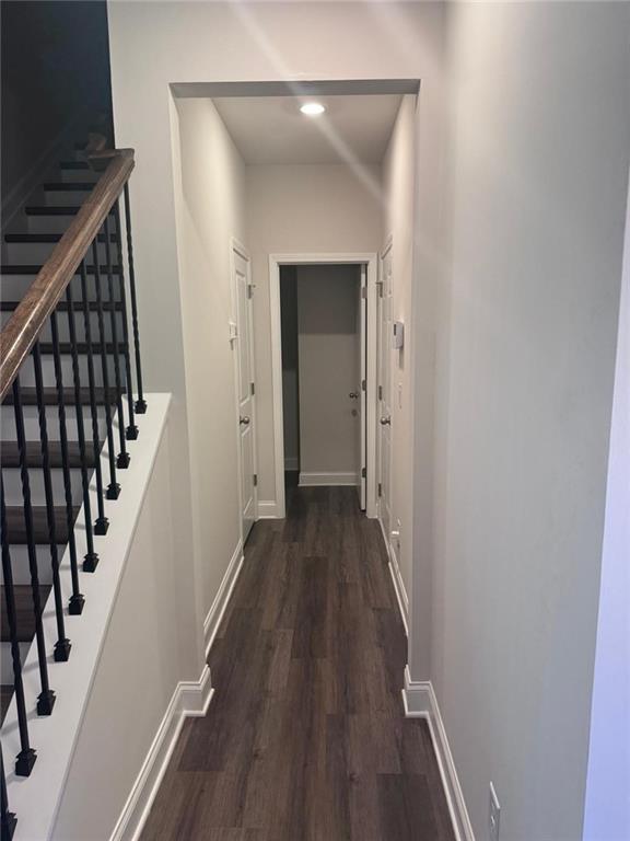 855 Pensive Run Dacula, GA 30019 - Photo 3 of 8 a view of a hallway with wooden floor and staircase