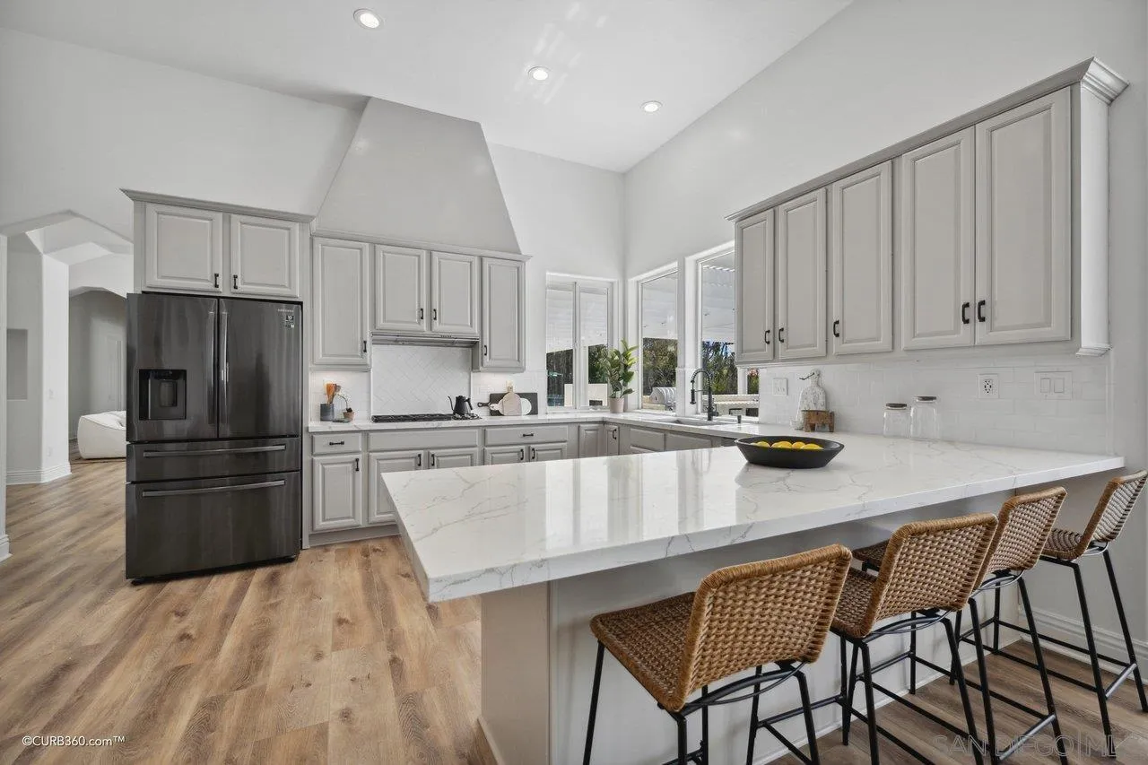 17035 Edina Court Poway, CA 92064 - Photo 12 of 52 a kitchen with kitchen island a counter space a sink appliances and cabinets