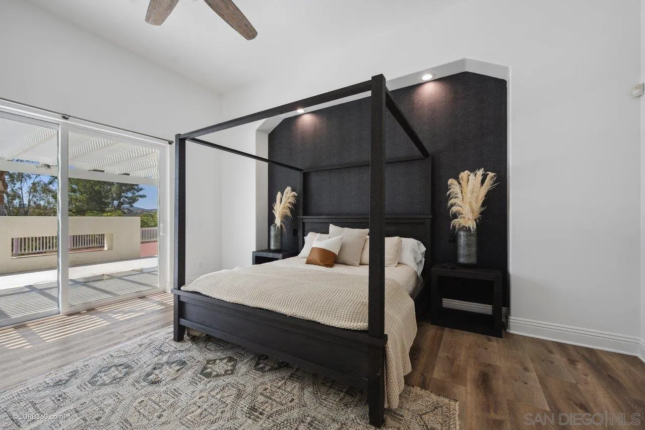 17035 Edina Court Poway, CA 92064 - Photo 22 of 52 a bedroom with a bed a mirror and glass door