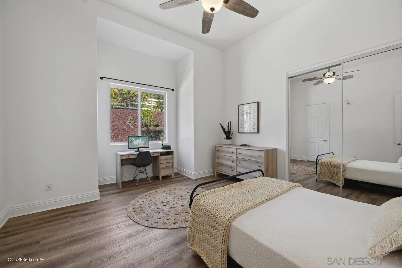 17035 Edina Court Poway, CA 92064 - Photo 29 of 52 a bedroom with a bed and a chandelier