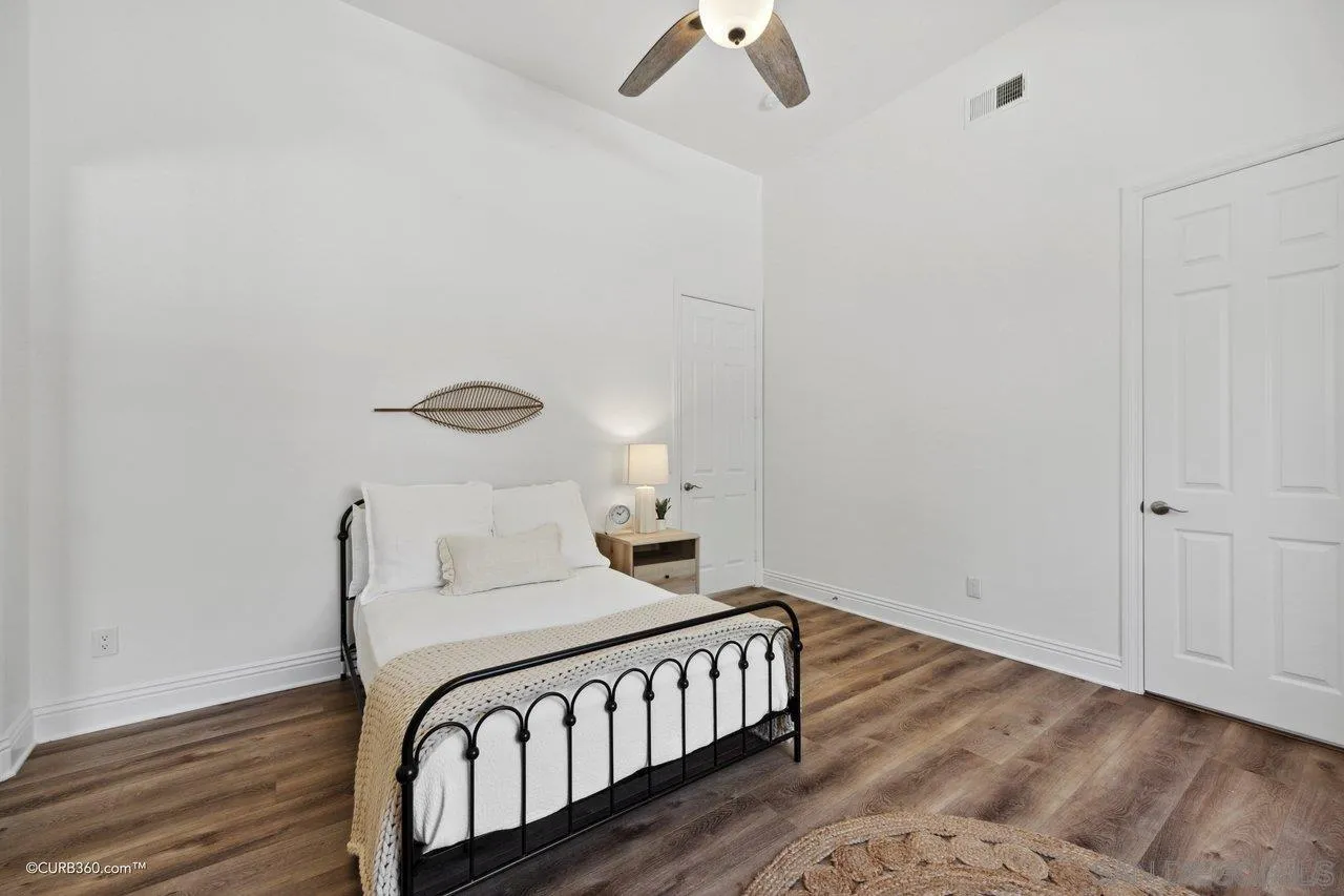 17035 Edina Court Poway, CA 92064 - Photo 30 of 52 a bedroom with a bed and wooden floor