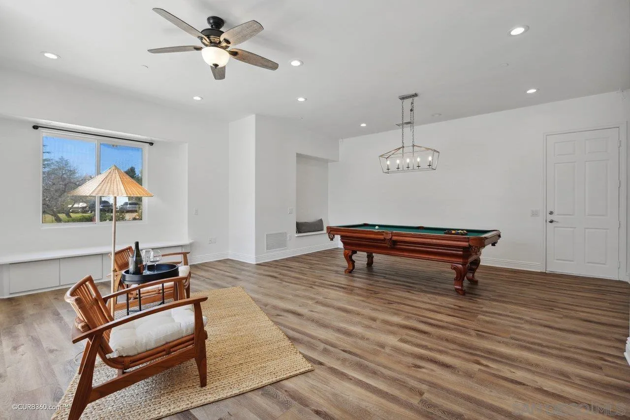 17035 Edina Court Poway, CA 92064 - Photo 36 of 52 a living room with furniture a rug and a chandelier