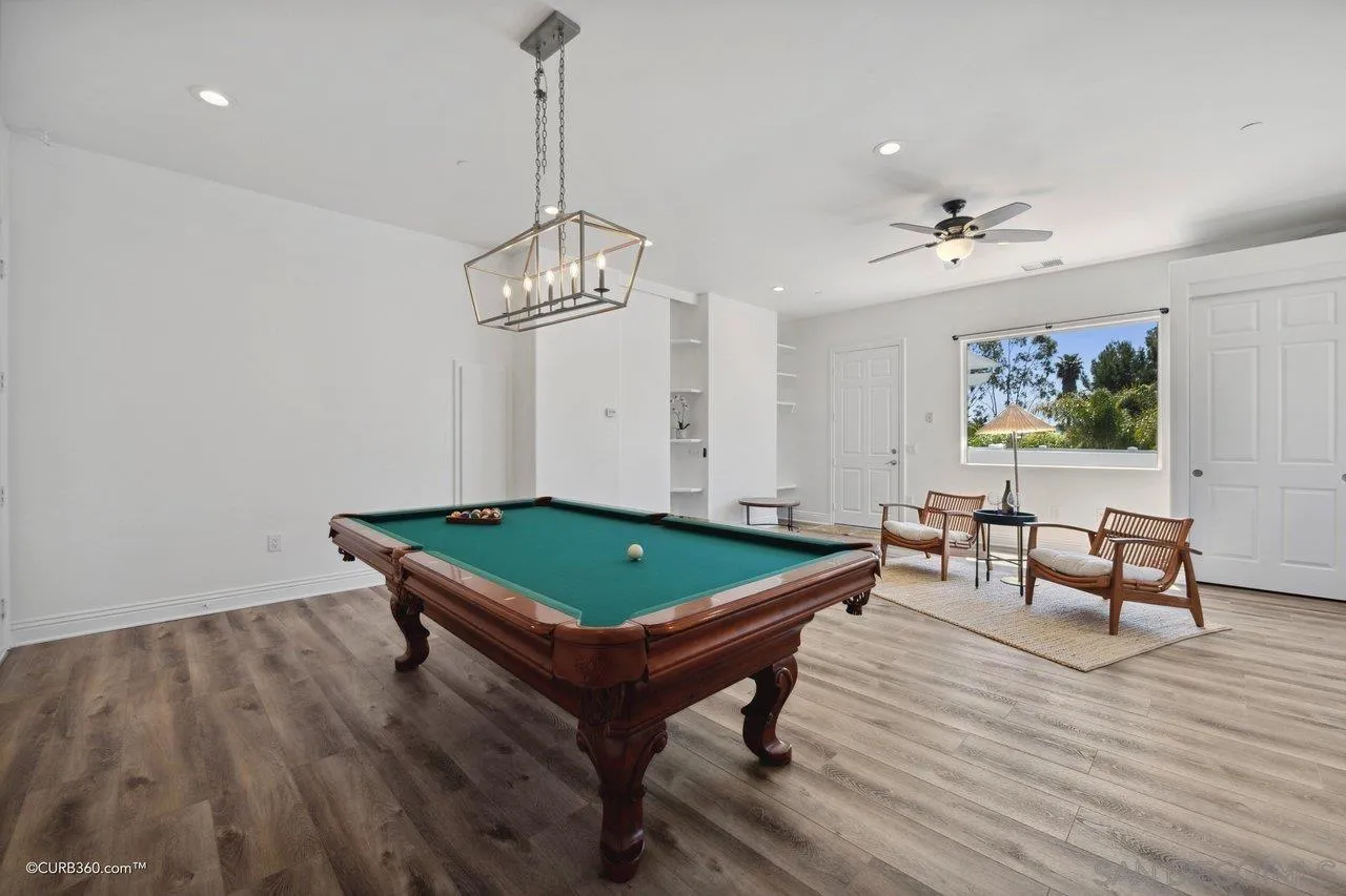 17035 Edina Court Poway, CA 92064 - Photo 38 of 52 a room with wooden floor pool table and windows