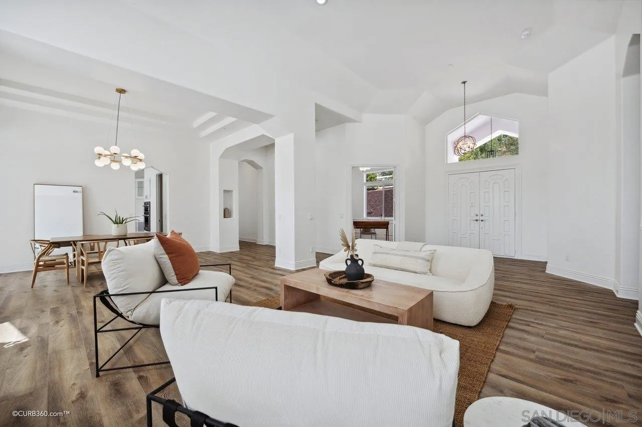 17035 Edina Court Poway, CA 92064 - Photo 6 of 52 a living room with furniture a chandelier and kitchen view