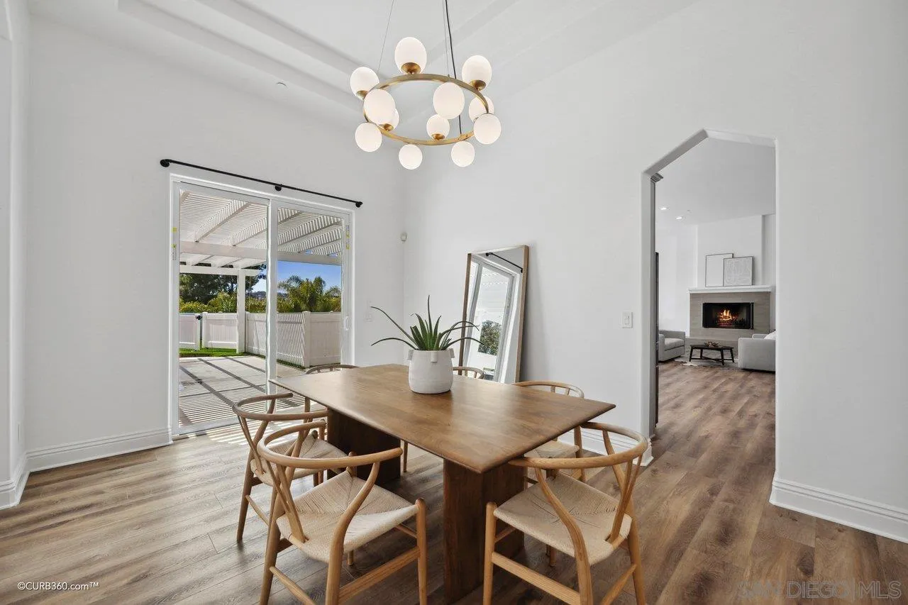 17035 Edina Court Poway, CA 92064 - Photo 9 of 52 a view of a dining room with furniture wooden floor and chandelier