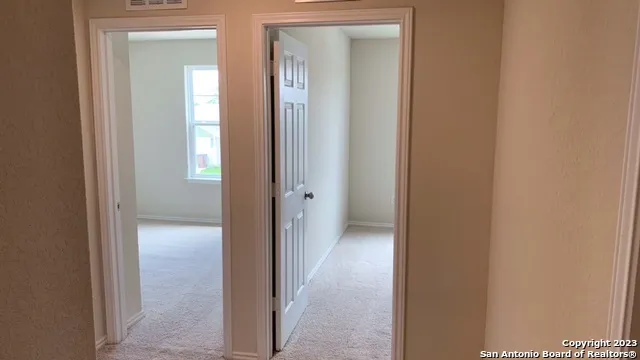 a view of a backyard with wooden fence
