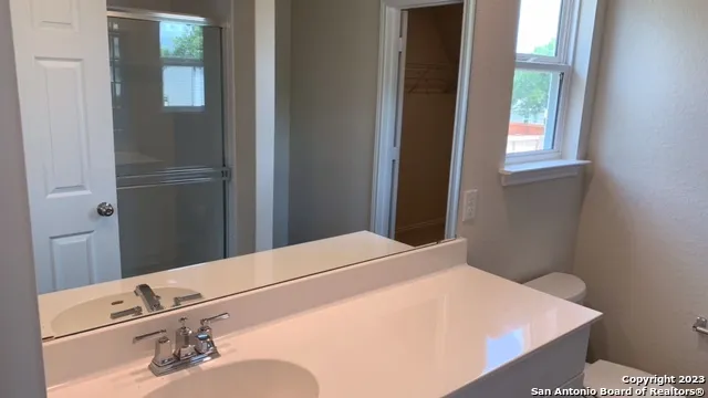 a room with a bed and a mirror