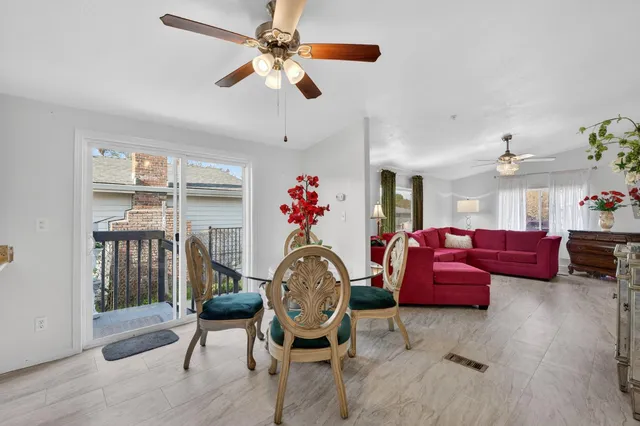 a living room with furniture a rug and a chandelier