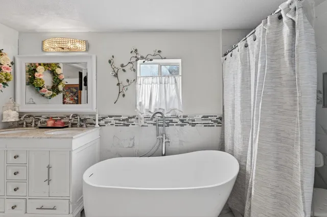 a bathroom with a bathtub and shower