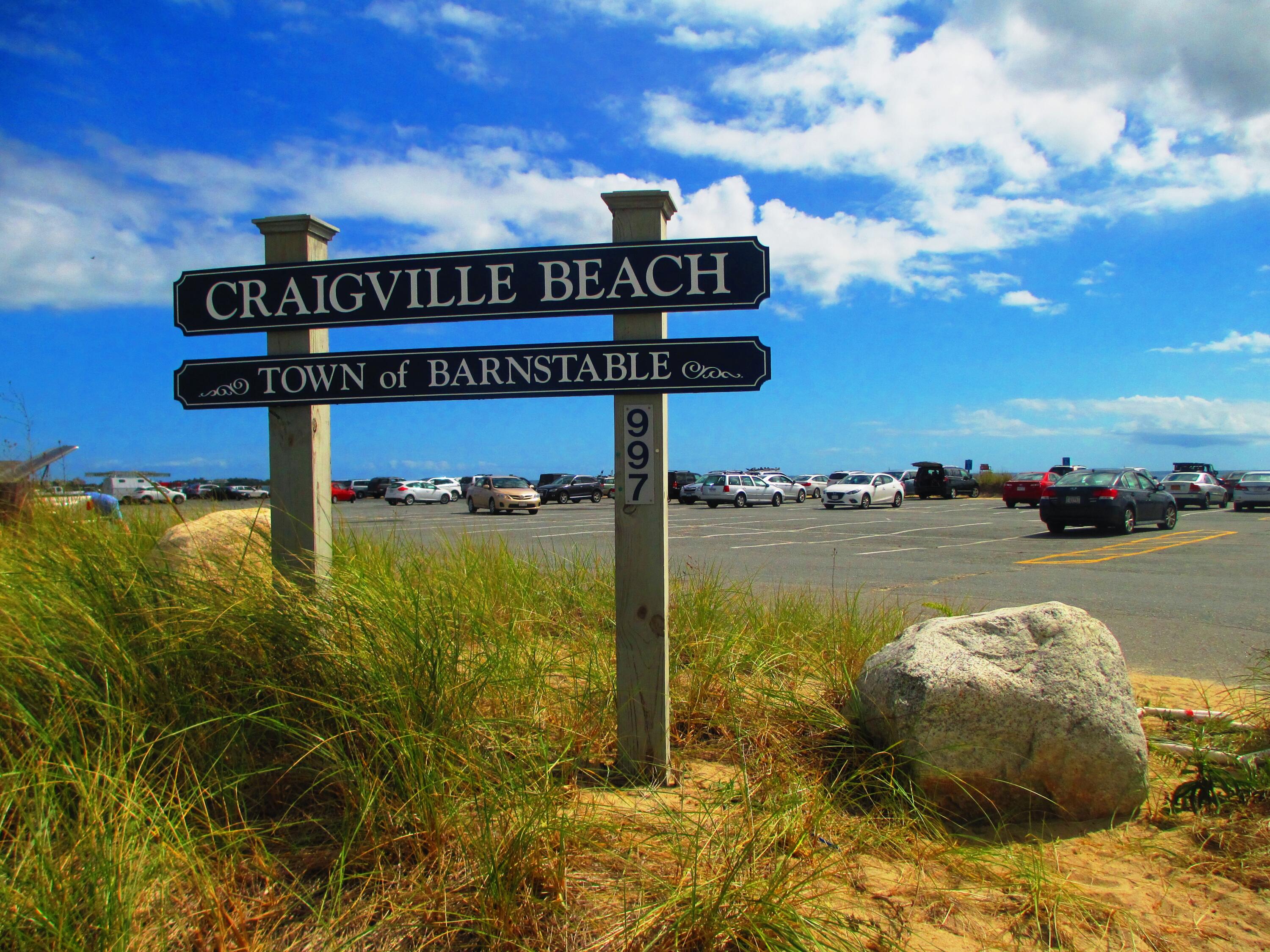 346 Old Stage Road Centerville, MA 02632 - Photo 22 of 23 a street sign on a wall next to a lake