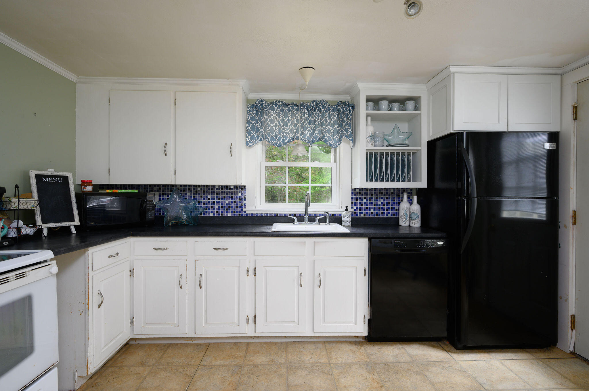 346 Old Stage Road Centerville, MA 02632 - Photo 9 of 23 a kitchen with granite countertop white cabinets and refrigerator