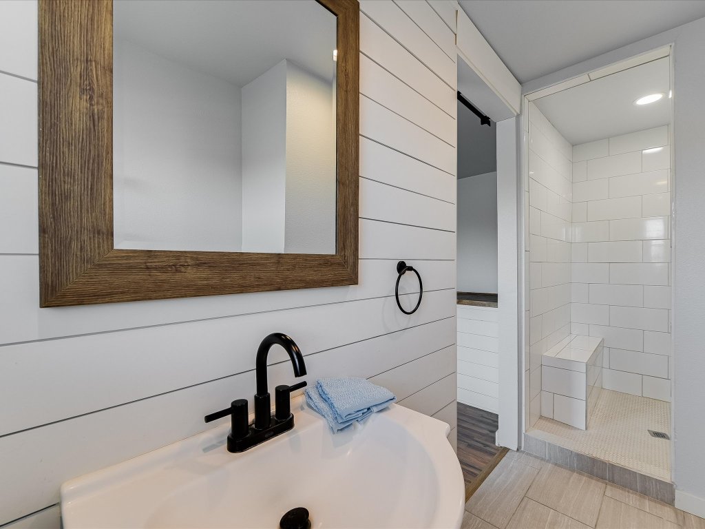 155 Travis Lane Spicewood, TX 78669 - Photo 13 of 33 a bathroom with a sink and a shower