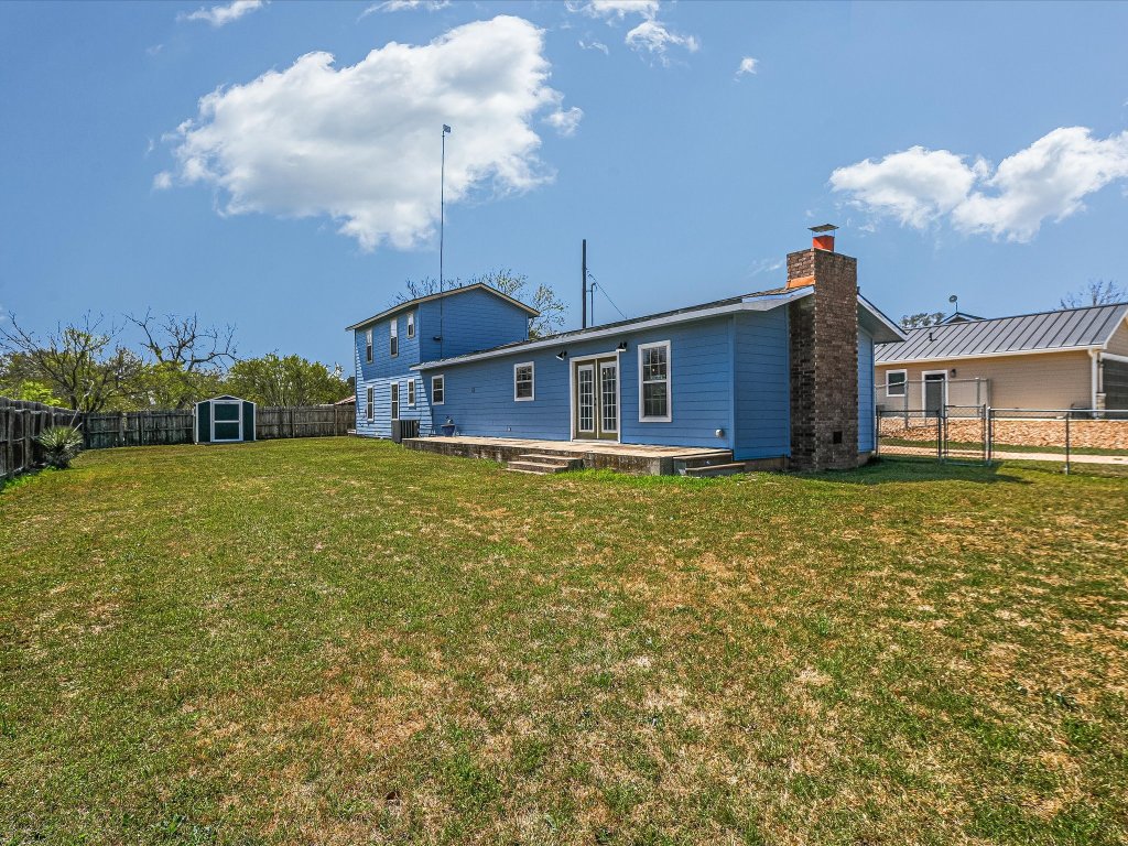 155 Travis Lane Spicewood, TX 78669 - Photo 18 of 33 a view of a house with a backyard