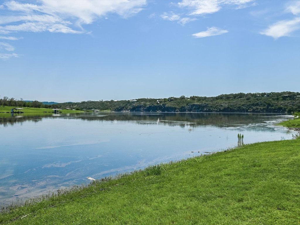 155 Travis Lane Spicewood, TX 78669 - Photo 27 of 33 a view of a lake with houses in the back