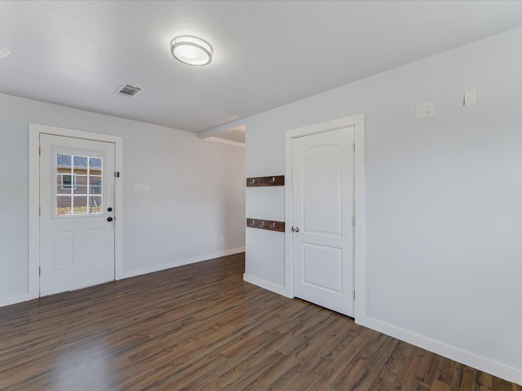 155 Travis Lane Spicewood, TX 78669 - Photo 9 of 33 a view of empty room with wooden floor