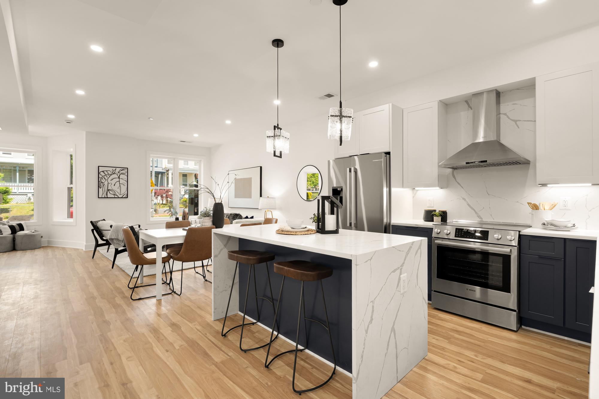 1251 Morse Street Northeast, Unit B Washington, DC 20002 - Photo 12 of 37 a kitchen with stainless steel appliances granite countertop a sink a stove a refrigerator and island with wooden floor